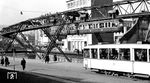 Schwebebahnzug Nr. 68 (Westwaggon/SSW, Baujahr 1950) kurz vor der Station Döppersberg in Wuppertal-Elberfeld. Unten ist noch der Beiwagen des Straßenbahnzuges auf der Linie 23 nach Ronsdorf zu erkennen. (28.02.1953) <i>Foto: Karl Wyrsch, Slg. D. Ammann</i>