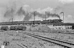 50 038 (Bw Ludwigshafen) fährt mit einem Güterzug am Bw Ludwigshafen (Rhein) vorbei. Unten stehen u.a. die ausgemusterten 74 696 und 74 476. (02.09.1963) <i>Foto: Wolfgang Jahn</i>