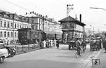Sonntäglicher Ausflugsverkehr am heute aufgelassenen Bahnübergang an der Wallbruchstraße in Lörrach mit der nach Basel ausfahrenden E 32 20. Links von der Lok ist das ehemalige Postamt zu sehen. Das Stellwerk 1 existiert heute noch, ging allerdings Ende 2004 vom Netz. (07.1958) <i>Foto: Jürgen Hagemann, Slg. R. Garn</i>