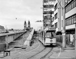 Die Straßenbahn in Freiburg im Breisgau besteht seit 1901 und war von Beginn an elektrifiziert. Während in vielen anderen Städten die Straßenbahn als Verkehrshindernis verschwand, gilt der Ausbau des Freiburger Streckennetzes seit 1980 als Beispiel für die Renaissance der Straßenbahn in Deutschland. Der GT 8-Triebwagen 203 (Duewag, Baujahr 1972) ist auf der Linie 4 nach Littenweiler in der Bertoldstraße unterwegs. Links entsteht gerade die neue Stühlingerbrücke über die Gleise des Hauptbahnhofs. Im Hintergrund ist die Herz Jesu Kirche zu sehen. (10.1981) <i>Foto: Reinhard Todt</i>