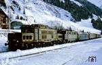 ÖBB 1020.38 (ex e 94 100) leistet 1670.22 Vorspann vor einem Personenzug auf der Arlbergstrecke in St. Anton. (15.03.1968) <i>Foto: Robin Fell</i>