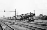 03 1074, eine der zwei DR-03.10 mit Oberflächenvorwärmer, leistet 78 447 Vorspann vor einem Personenzug bei der Ausfahrt aus Stralsund. (1967) <i>Foto: Robin Fell</i>