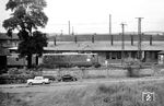 Vorserienlok E 10 004 vom Bw Nürnberg Hbf fährt mit einem Schnellzug am Bw Aschaffenburg in Richtung Spessart vorbei. An der Lok klebt ein Werbeplakat für die IVA in München. (27.06.1965) <i>Foto: Reinhard Gumbert</i>