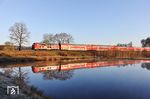 Der frühe Vogel fängt den Wurm - oder anders gesagt, eine Spiegelung an den Geisteichen bei Wiesau gelingt nur bei windstillem Tagesbeginn. Um 7.16 Uhr röhrt 218 433 mit RE 4857 nach München durch die morgendliche Stille. (07.04.2026) <i>Foto: Joachim Bügel</i>