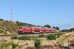 218 453 mit RE 11068 aus Niebüll an der neu entstandenen Heidefläche östlich von Morsum. Wie man sieht, holt sich das Buschwerk die gerodete Fläche bereits wieder zurück. (24.08.2026) <i>Foto: Joachim Bügel</i>