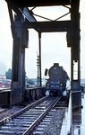 012 074 wird mit E 1631 über die Klappbrücke am Emdener Hafen gleich in Emden Hbf einfahren. (04.1971) <i>Foto: Jürgen Hagemann</i>