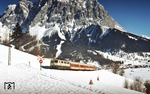 111 099 mit einem Nahverkehrszug von Innsbruck nach Reutte/Tirol ("Korridorzug") vor der Kulisse der Zugspitze bei Leermoos. (04.02.1982) <i>Foto: Peter Schiffer</i>