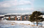 Ein kurzer Wintereinbruch im April tauchte die Schwarzwaldlandschaft wieder in ein weißes Kleid. Mit E 1946 am Haken kachelt 038 711-8 (38 3711) über die Kübelbachbrücke bei Dornstetten. Ganz im Hintergrund liegt Freudenstadt. (04.04.1973) <i>Foto: Wolfgang Bügel</i>