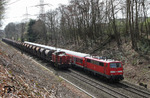 Die den RB 11119 nach Köln schiebende 111 114 begegnet bei Leichlingen einem Schotterzug mit der BBL Logistic 08, die noch die Beschriftung der ex KUBE CON Lok 19 trägt und hinter der sich die ehemalige DR 110 324 verbirgt. (20.03.2014) <i>Foto: Joachim Bügel</i>