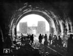 Beim Rückzug der deutschen Heeresgruppe B auf die rechte Rheinseite im Frühjahr 1945 sollten nach dem Willen der Wehrmachtsführung alle Rheinbrücken gesprengt werden. Bei der Ludendorff-Brücke zwischen Remagen und Erpel -besser bekannt als die Brücke von Remagen- wurden jedoch zu wenig (300 kg statt 600 kg) und ineffektiver Sprengstoff (Donarit statt Dynamit) verwendet. Bei der Sprengung wurde die Brücke nur kurz aus ihren Lagern gehoben, jedoch nicht zerstört. Am 7. März 1945 um 13:00 Uhr erreichte eine Vorhut der 9. US-Panzerdivision die intakte Brücke. Innerhalb von 24 Stunden überquerten dann 8.000 alliierte Soldaten den Rhein in Richtung Ostufer. Von deutscher Seite wurde in der Folge vergeblich versucht, die Brücke zu zerstören. Zwischen dem 8. und 9. März 1945 schossen die Deutschen ca. 3000 Granaten auf die Brücke, jedoch ohne wesentliche Treffer. Am 10. März 1945 begann ein deutscher Gegenangriff, der aber zu schwach war, um noch Erfolg zu haben. Auch versuchten deutsche Kampfschwimmer in den nächsten Tagen immer wieder vergeblich, die Brücke zu zerstören. Zudem versuchte die Luftwaffe vom 8. bis zum 12. März 1945 vergeblich, die Brücke durch Bombenangriffe zum Einsturz zu bringen. Allein am 12. März 1945 schossen die Amerikaner 26 Flugzeuge ab und beschädigten 9 weitere von insgesamt 91 angreifenden Flugzeugen. Zwischen dem 11. und 17. März wurden sogar aus den Niederlanden elf V2-Raketen auf die Brücke abgeschossen. Eine Rakete schlug zwar in rund 270 m Entfernung östlich von der Brücke in ein Haus ein, drei Raketen landeten unweit der Brücke im Rhein, fünf weitere westlich der Brücke. Die Brücke blieb aber (noch) stehen. (11.03.1945) <i>Foto: Pressefoto ACME</i>