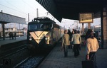 Die mit einem Versuchs-Warnanstrich versehene 110 365 läuft vor einem Eilzug nach Mittenwald in München-Pasing ein. (17.02.1975) <i>Foto: Peter Schiffer</i>