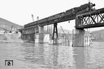 39 155 (Bw Heidelberg) vor E 580 nach Kaiserslautern auf der nur eingleisig befahrbaren Notbrücke über den Neckar bei Neckargemünd. Auf der Kleingemünder Seite wurde hierfür extra die "Abzw Kleingemünd" eingerichtet. Die Brücke wurde noch 1958 repariert. (30.03.1958) <i>Foto: Helmut Röth *</i>