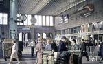 Blick in die Haupthalle des Münchener Hauptbahnhofs mit den Schaltern für Handgepäck und Schließfächern sowie einem stilisierten VT 11, der eine gute Reise wünscht. Die Stahlkonstruktion der Haupthalle wurde 1960 von der Friedrich Krupp AG entworfen und gefertigt. (1974) <i>Foto: Reinhold Palm</i>