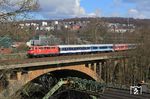 111 056 der GfF mit dem bunt zusammengewürfelten NX-Ersatzzug RB 32517 nach Bonn auf der Wupperbrücke in Wuppertal-Sonnborn. (19.03.2021) <i>Foto: Wolfgang Bügel</i>