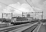 Die Elektroloks der Serie 25 der SNCB entstanden 1960/61 in 22 Exemplaren. Sie sollten hauptsächlich Schnellzüge auf der Magistrale Ostende - Lüttich befördern. Dazu wurden 6 Maschinen mit einer Geschwindigkeit von 140 km/h umgebaut; aerodynamische Probleme führten aber dazu, dass sie wieder auf 130 km/h reduziert wurde. 1973 war die Verbindung Brüssel - Amsterdam stark überlastet, da sich die Passagierzahlen seit 1957 mehr als verdoppelt hatten. Die Züge brauchten aber über 5 Stunden für die Strecke, da in Antwerpen Kopf gemacht werden musste und in Roosendaal ein Lokwechsel zur NS stattfand. Daher wurde beschlossen, die Züge mit Steuerwagen auszustatten und Lokomotiven einzusetzen, die sowohl in Belgien wie auch in den Niederlanden verkehren konnten. Dazu wurden 8 Maschinen der Serie 25 umgebaut und als Serie 25.5 einsortiert. Dies waren die ehemaligen 2515 - 2522, neu 2551 - 2558. Die Maschinen wurden passend zu den Wagen in der sogenannten Benelux-Livrée (blau-gelb) lackiert, außerdem wurde aus Platzgründen nur noch ein Stromabnehmer eingebaut. Dies machte es einfach, die Serie 25.5 von den Maschinen der Serie 25 zu unterscheiden. SNCB 2554, eine Lok aus der Serie 25.5, erreicht hier mit einem Schnellzug den Bahnhof Venlo in den Niederlanden. (1972) <i>Foto: Wolf Hanisch</i>