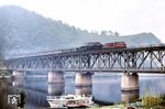 001 073, der eine unbekannte 216 vorgespannt wurde, fährt mit E 1570 aus Trier über die doppelstöckige Moselbrücke nach Bullay ein.  (26.09.1970) <i>Foto: Robin Fell</i>