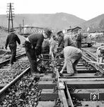 Einpassen eines Gleisstückes in eine Weiche im Bahnhof Neckargemünd. Neben der Einhaltung der Überhöhungsmaße in dem Gleisbogen war auch das exakte Spurmaß zu beachten. Dafür sorgte die auf den Schienenköpfen aufgelegte Lehre im Vordergrund. (29.03.1963) <i>Foto: Alfred Volk</i>