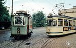 Zwei Generationen von Straßenbahnen begegnen sich im Betriebshof Baumgartnerstraße vor dem Roten Tor in Augsburg. Links der museal erhalten gebliebene Tw 14 (MAN, Baujahr 1898), rechts Tw 519 (MAN/MGB, Baujahr 1956). (29.05.1965) <i>Foto: Theodor Horn</i>