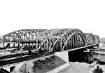 Die Hamburger Elbbrücken sind mehrere voneinander unabhängige Brückenbauwerke, die in Hamburg die Elbe überspannen. Sie verbinden die nördlich gelegenen Stadtteile mit den Elbinseln, dem Hafengebiet und dem südlich der Elbe gelegenen Bezirk Harburg. Darüber hinaus haben sie eine bedeutende überregionale Funktion als Nord-Süd-Verbindung im Eisenbahnverkehr. Die Eisenbahnbrücke über die Norderelbe (Foto) besteht aus zwei separaten Brücken: Die erste Norderelbebrücke (auch Alte Elbbrücke) wurde 1868–1872 für die Hamburg-Venloer Bahn der Köln-Mindener Eisenbahn-Gesellschaft gebaut. Die Brückenbaugesellschaft Harkort in Duisburg war mit der Errichtung der zweigleisigen Brücke beauftragt; die architektonische Gestaltung oblag Heinrich Strack. Die eisernen Überbauten wurden zwischen 1890 und 1893 von zwei auf vier Gleise erweitert und auch die Portale entsprechend verbreitert. Von 1926 bis 1927 wurden die Brückenträger durch stärkere Neubauten ersetzt.  (1928) <i>Foto: RVM</i>