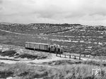 Diesellok 7 (DWK, Baujahr 1937) mit dem Güterwagen GG 52 (ex PwPost 52, Busch, Baujahr 1906) zwischen Klappholtal und Vogelkoje auf der Sylter Nordbahn. (24.09.1968) <i>Foto: Reinhard Todt</i>