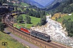 Die Gotthardbahn ist eine rund 200 km Gebirgsstrecke von Arth-Goldau (Schweiz) nach Chiasso (Italien). In Zukunft soll die gesamte Bergstrecke der Gotthardbahn durch den Gotthard-Basistunnels auf 57 km Länge unterfahren werden. Dann wird diese schöne Fotostelle bei Wassen mit SBB/CFF Re 6/6 11654, die einer unbekannten Re 4/4 Vorspann leistet, Vergangenheit sein. (09.08.1997) <i>Foto: Christoph Weinkopf</i>