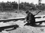 Begutachtung einer Sprengstelle durch einen bewaffneten "blauen" Eisenbahner.  (1943) <i>Foto: RVM (Korte)</i>